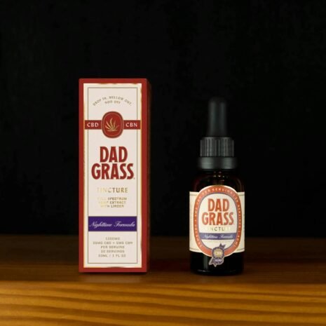 High-quality still life of Dad Grass CBD tincture highlighting packaging and bottle.